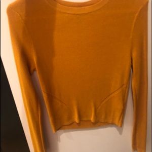 A yellow sweater/shirt with distressed details!